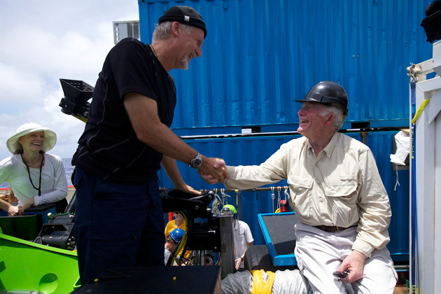 <em>Photo by Mark Thiessen/National Geographic</em><br> Don Walsh (right) congratulates Cameron after the latter's successful dive to 35,756 feet (10,898 meters) in the Challenger Deep.